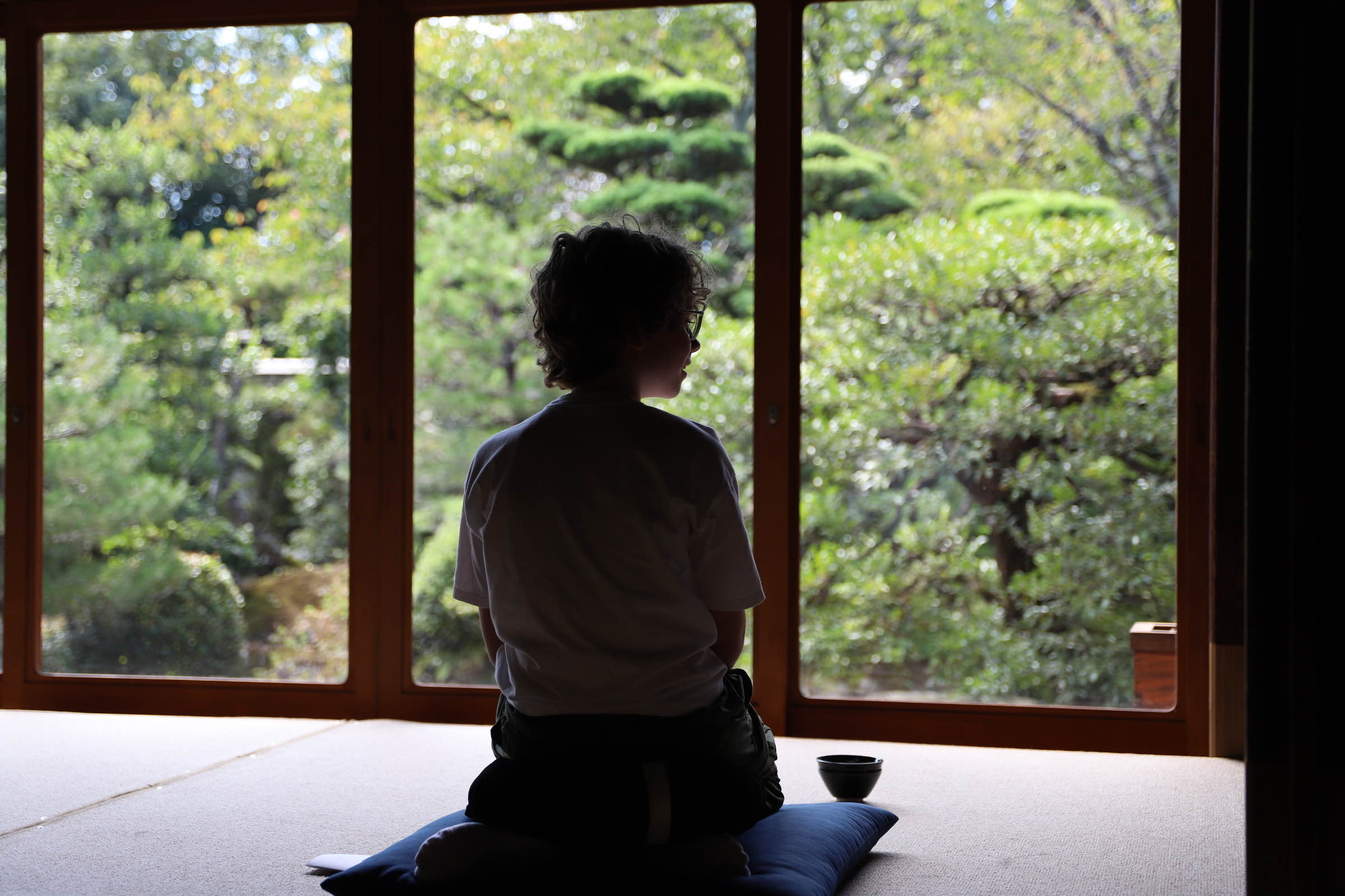 Visitor practicing zazen facing the garden at Jushoin Temple, Kyoto