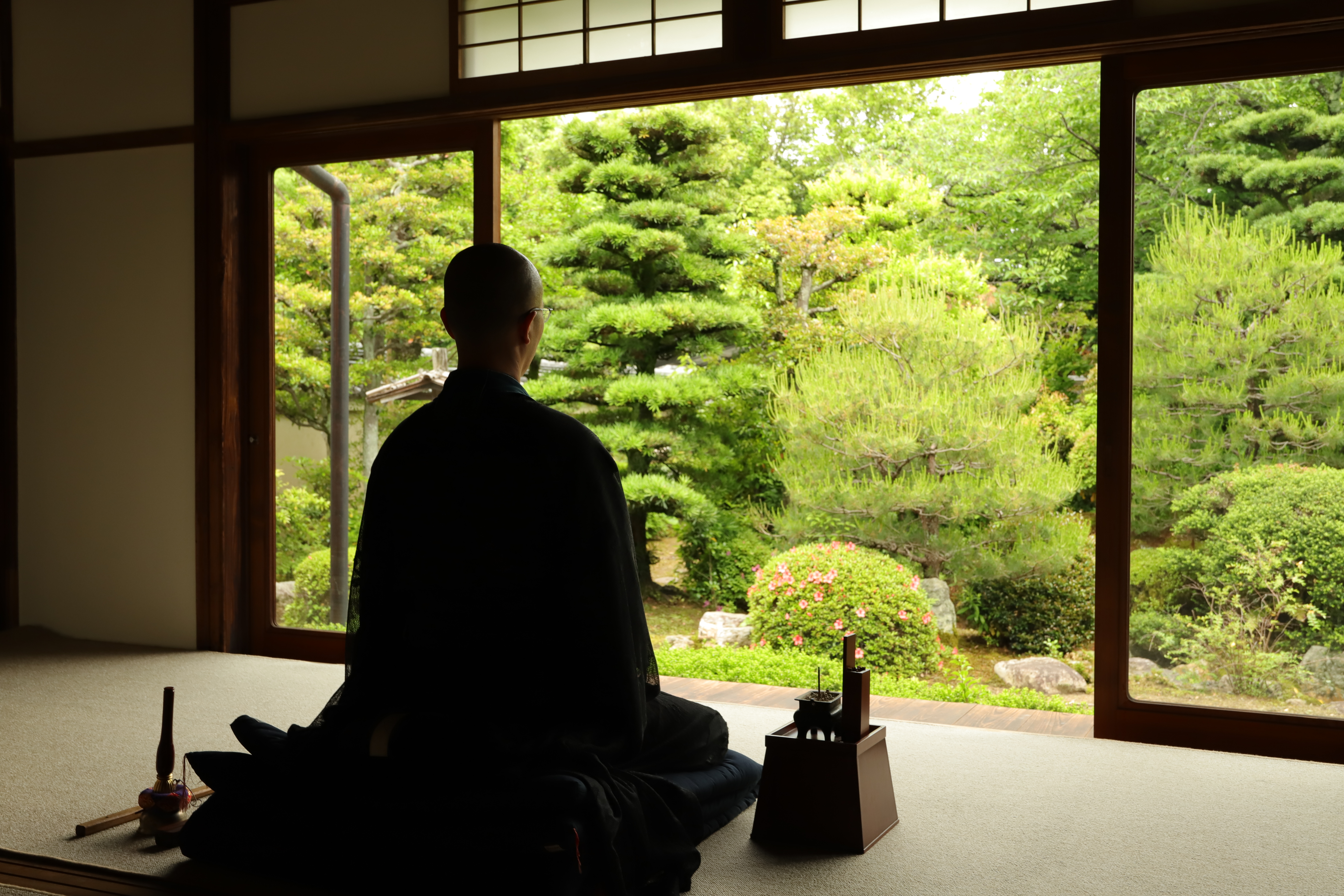 Zen monk in meditation facing garden at Jushoin Temple, Kyoto